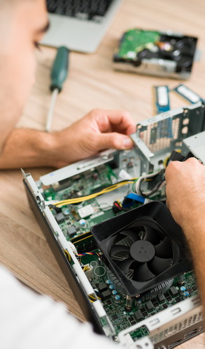 latin man checking the hardware of a computer